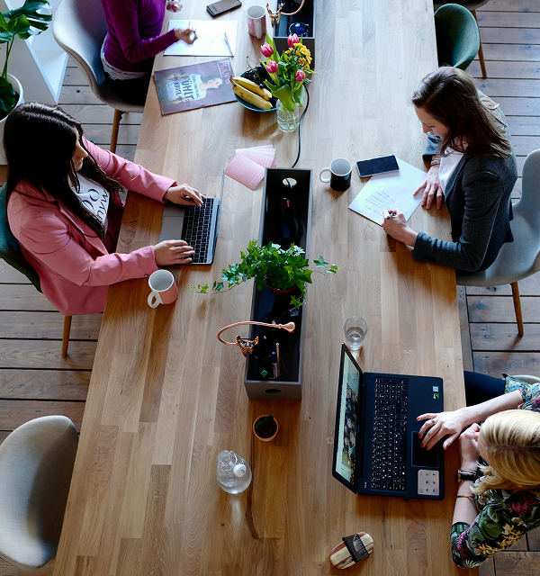 Overhead shot of adults on computers
